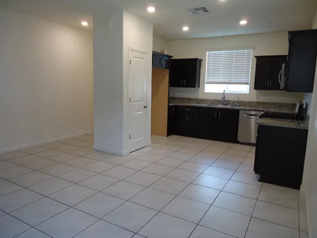 a kitchen with stainless steel appliances granite countertop a stove and a microwave