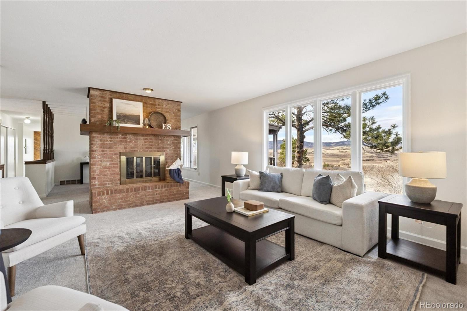 1482 North Perry Park Road Sedalia, CO 80135 - Photo 15 of 50 a living room with furniture a fireplace and a table