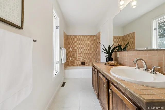 a view of a livingroom and a hall with an entryway