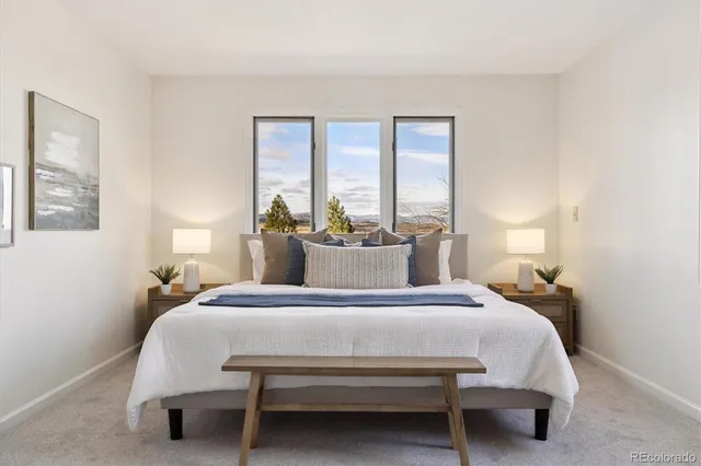 a spacious bedroom with a bed and a couch