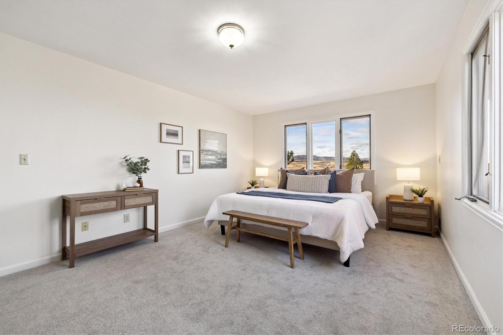 1482 North Perry Park Road Sedalia, CO 80135 - Photo 35 of 50 a spacious bedroom with a bed and a couch