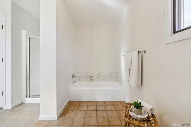 a spacious bathroom with a double vanity sink a mirror and a shower