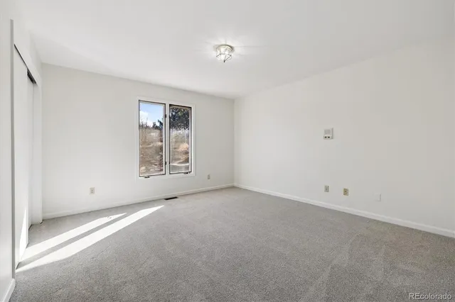 a view of a livingroom with an empty space and a window