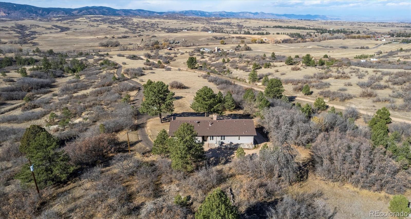 1482 North Perry Park Road Sedalia, CO 80135 - Photo 8 of 50 an aerial view of a house with a yard and mountain view