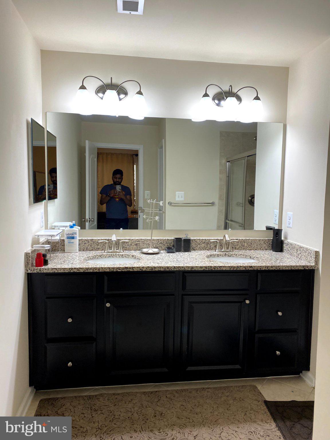 7014 Foxton Way Hanover, MD 21076 - Photo 8 of 29 Sleek modern bathroom with dual sinks.