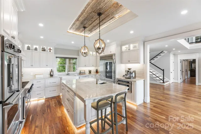 a large kitchen with a table and chairs