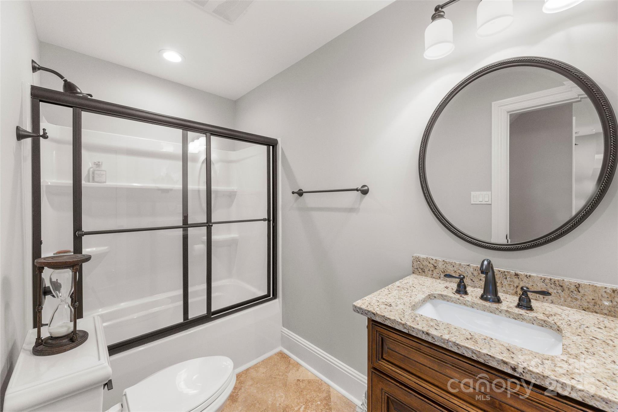 605 Recore Rdg Road Bessemer City, NC 28016 - Photo 26 of 48 a bathroom with a granite countertop sink a toilet and a mirror