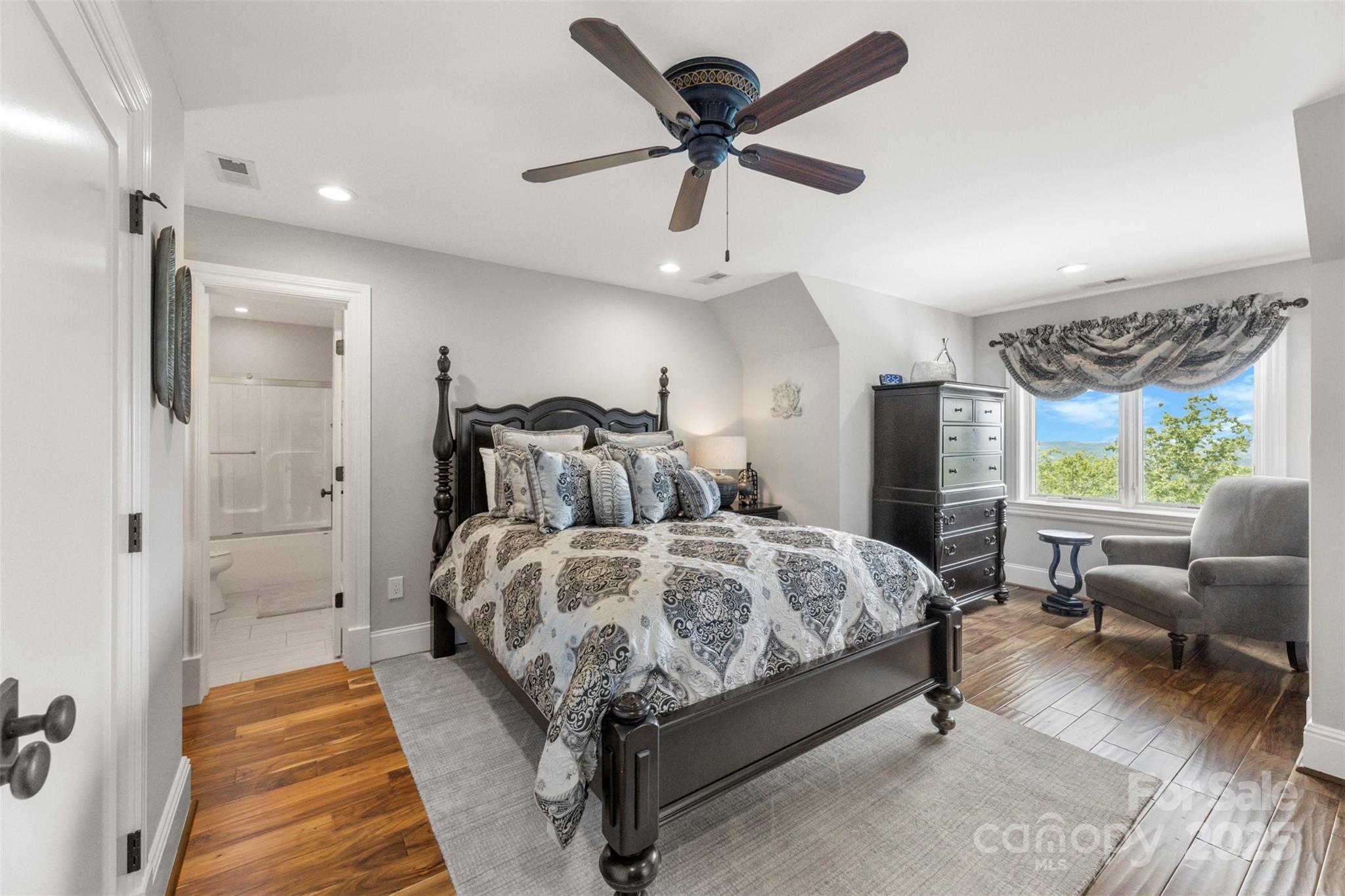 605 Recore Rdg Road Bessemer City, NC 28016 - Photo 27 of 48 a spacious bedroom with a bed a couch and a ceiling fan