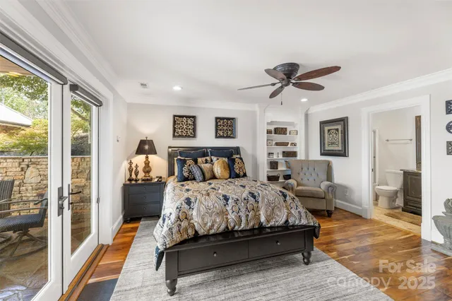 a bedroom with a bed and glass walk in closet