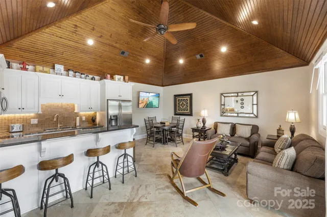 a living room with lots of furniture and a chandelier