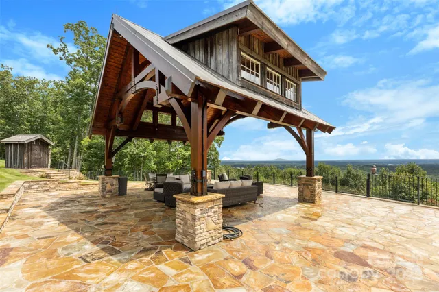 a view of a house with backyard and sitting area