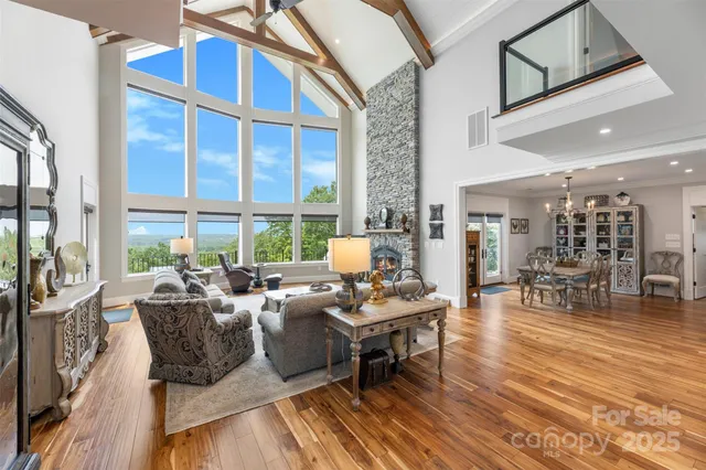 a living room with furniture and large windows