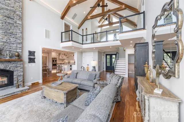 a living room with furniture a fireplace and a ceiling fan
