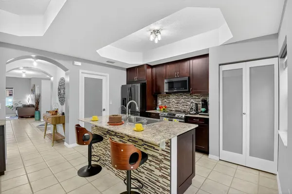 a kitchen with stainless steel appliances granite countertop a stove refrigerator and cabinets