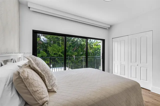 a bedroom with two beds and a large window