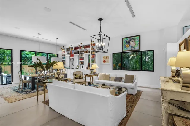 a living room with furniture a flat screen tv and a large window