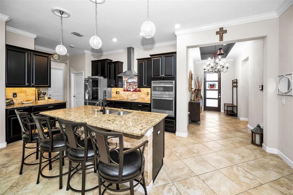 16833 Banner Shell Place Wimauma, FL 33598 - Photo 12 of 55 a large kitchen with a table and chairs