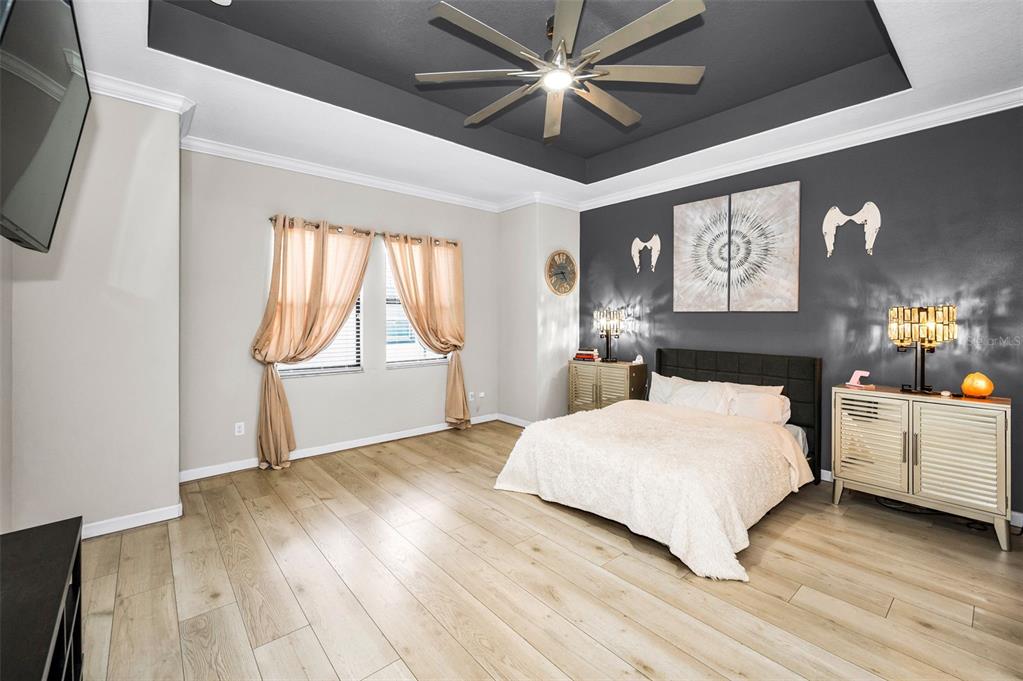 16833 Banner Shell Place Wimauma, FL 33598 - Photo 19 of 55 a bedroom with a large bed and a large window