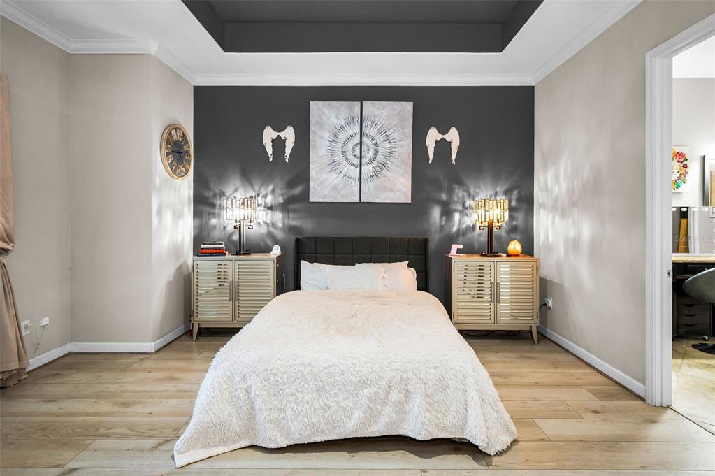 16833 Banner Shell Place Wimauma, FL 33598 - Photo 20 of 55 a bedroom with a large bed and a chandelier