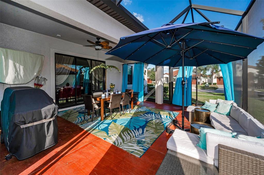 16833 Banner Shell Place Wimauma, FL 33598 - Photo 28 of 55 a view of a patio with couches chairs and a umbrella