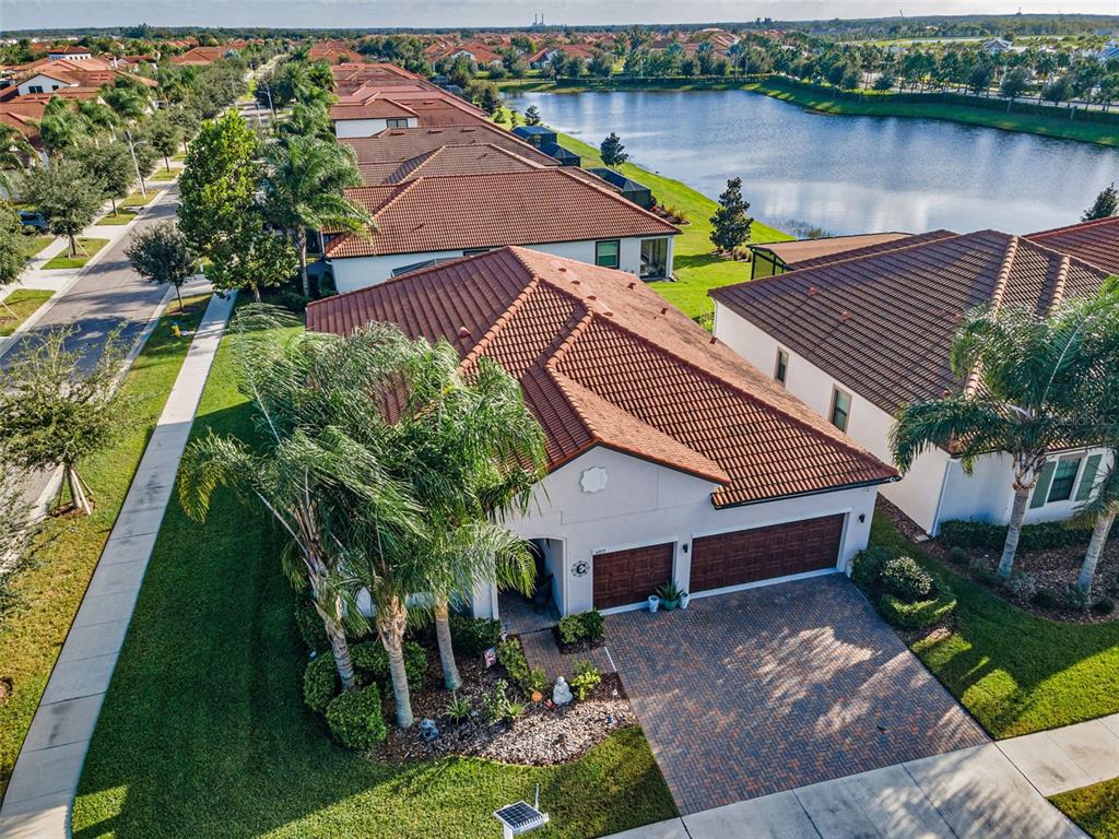 16833 Banner Shell Place Wimauma, FL 33598 - Photo 35 of 55 an aerial view of a house with garden space and a patio