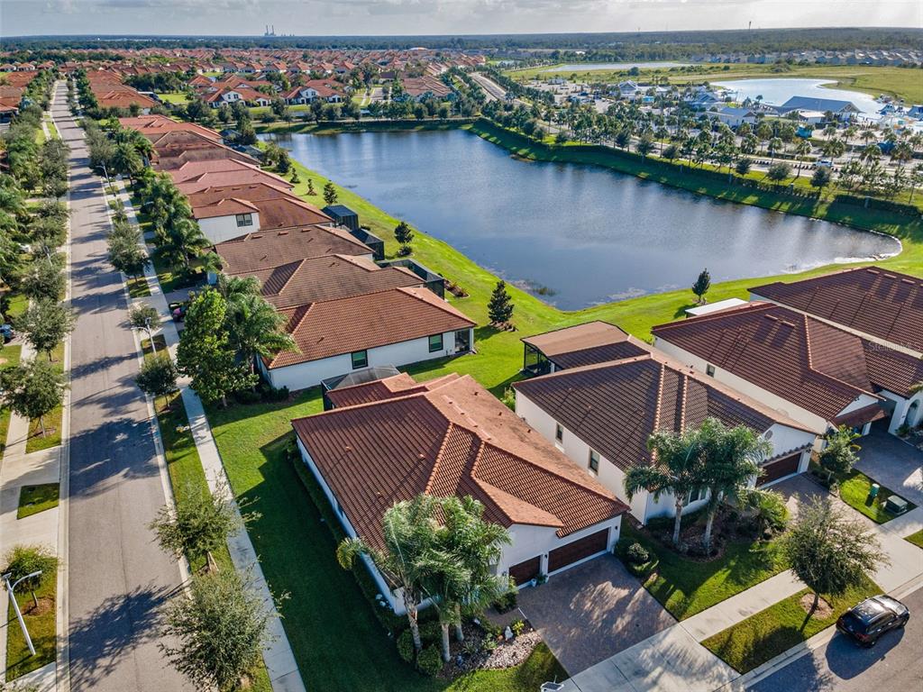 16833 Banner Shell Place Wimauma, FL 33598 - Photo 38 of 55 an aerial view of house with yard and lake view