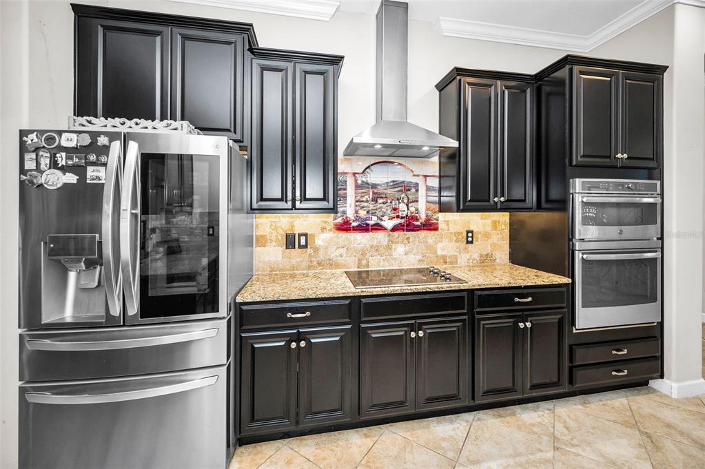16833 Banner Shell Place Wimauma, FL 33598 - Photo 8 of 55 a kitchen with granite countertop stainless steel appliances and cabinets