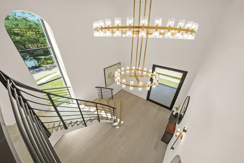 a view of a livingroom with furniture wooden floor chandelier