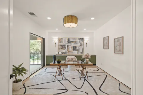 a view of a dining room with furniture and a potted plant