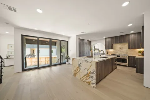 a large white kitchen with a large window