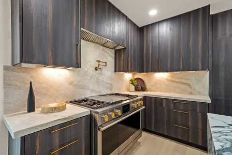 a kitchen that has a sink and a stove