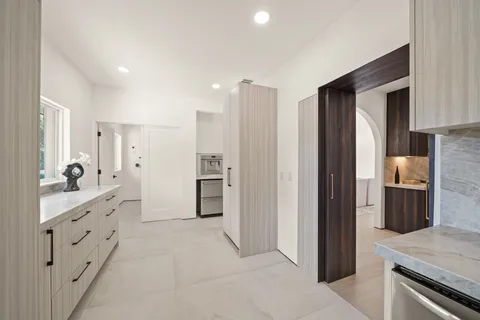 a kitchen with cabinets and stainless steel appliances
