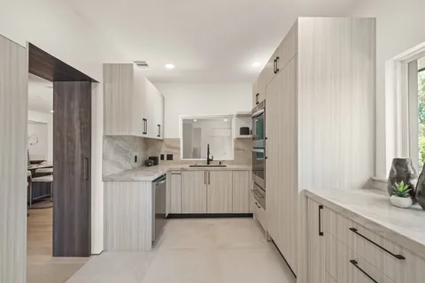 a kitchen with cabinets and stainless steel appliances