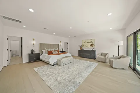 a spacious bedroom with a bed and couch