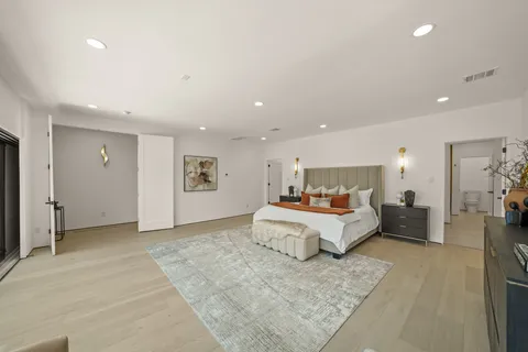 a spacious bedroom with a bed and a couch