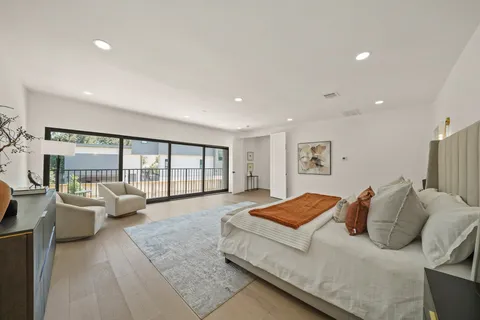 a living room with furniture and large windows