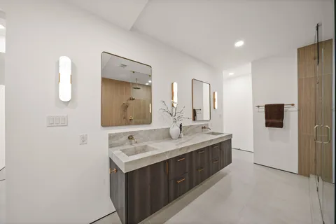 a bathroom with a granite countertop sink mirror and double
