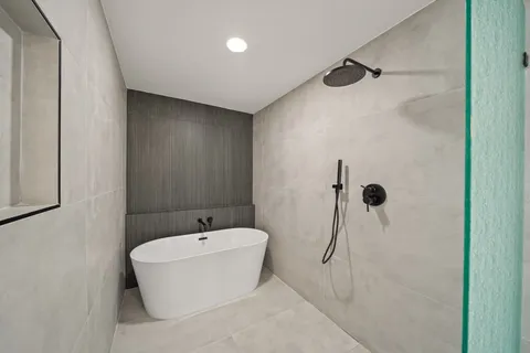 a bathroom with a bathtub and shower