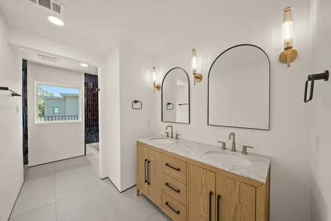 a bathroom with a double vanity sink and a mirror