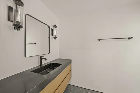 a bathroom with a sink and mirror