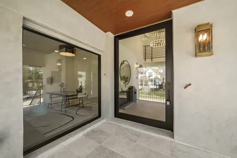 a bathroom with a glass shower door and mirror