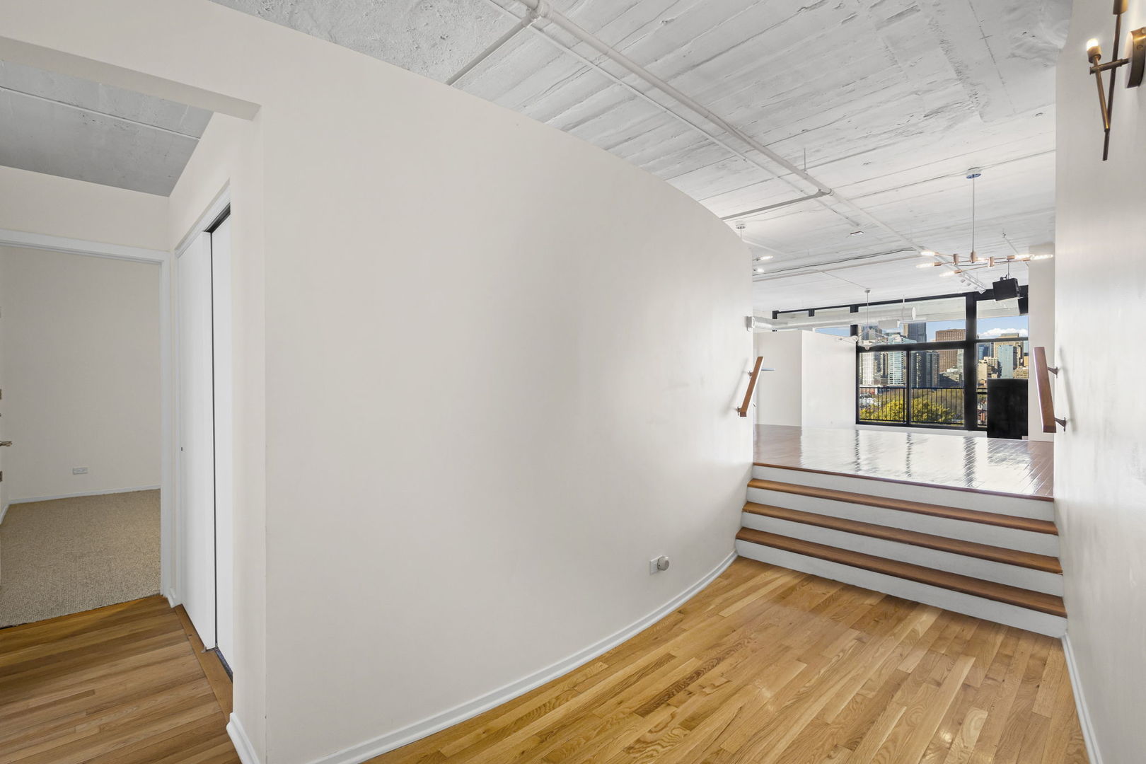 1530 South State Street, Unit 706 Chicago, IL 60605 - Photo 5 of 24 a view of a room with wooden floor and white walls