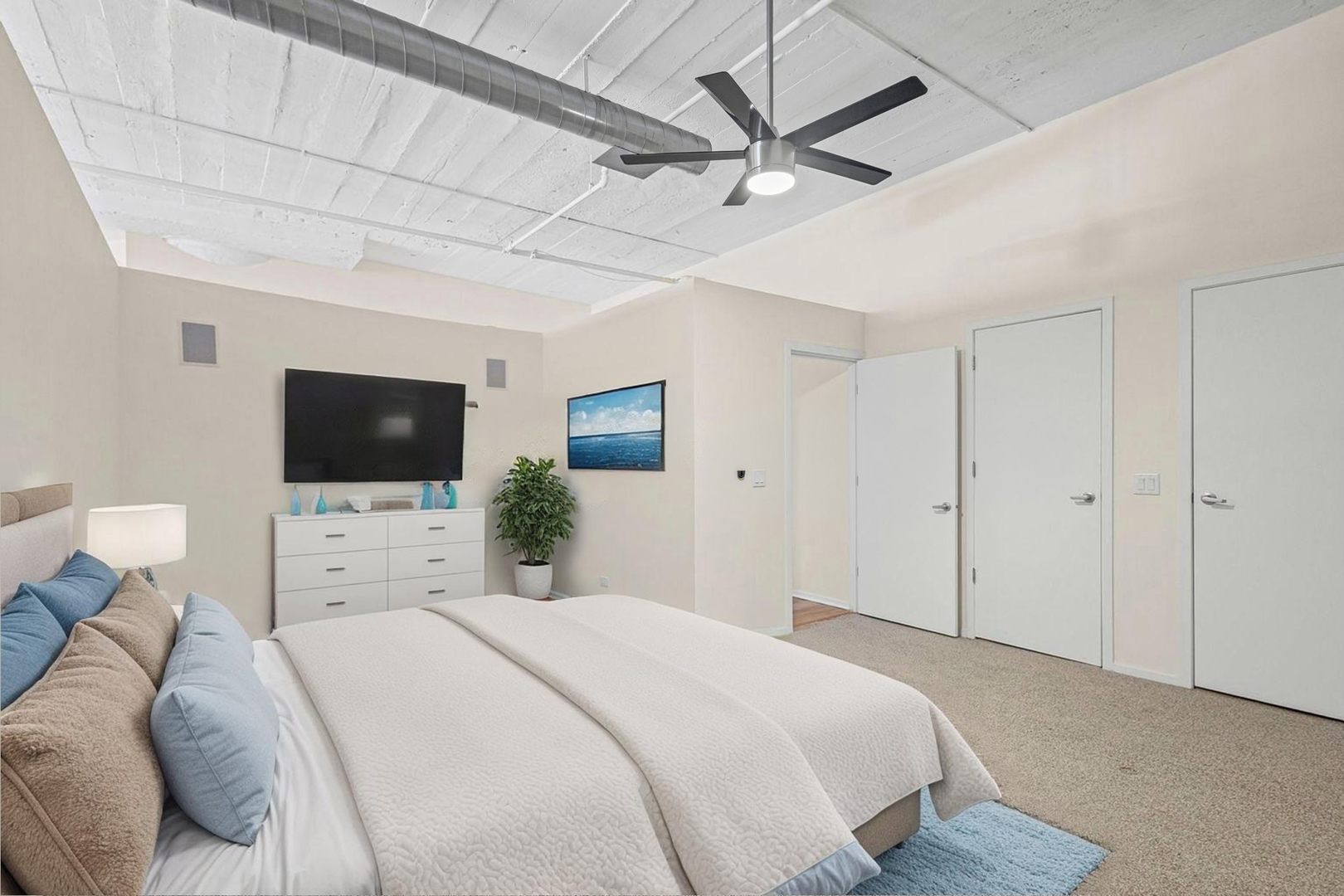 1530 South State Street, Unit 706 Chicago, IL 60605 - Photo 8 of 24 a bedroom with a bed a flat screen tv and a couch