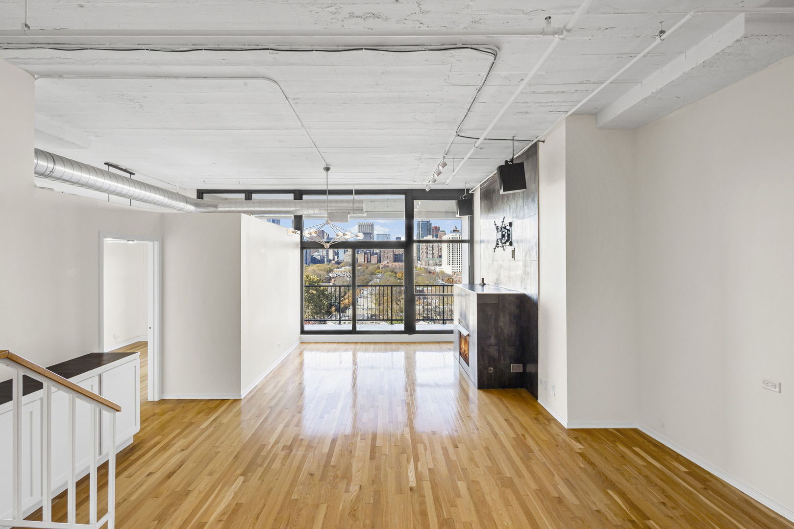 1530 South State Street, Unit 706 Chicago, IL 60605 - Photo 9 of 24 a view of a room with wooden floor and furniture