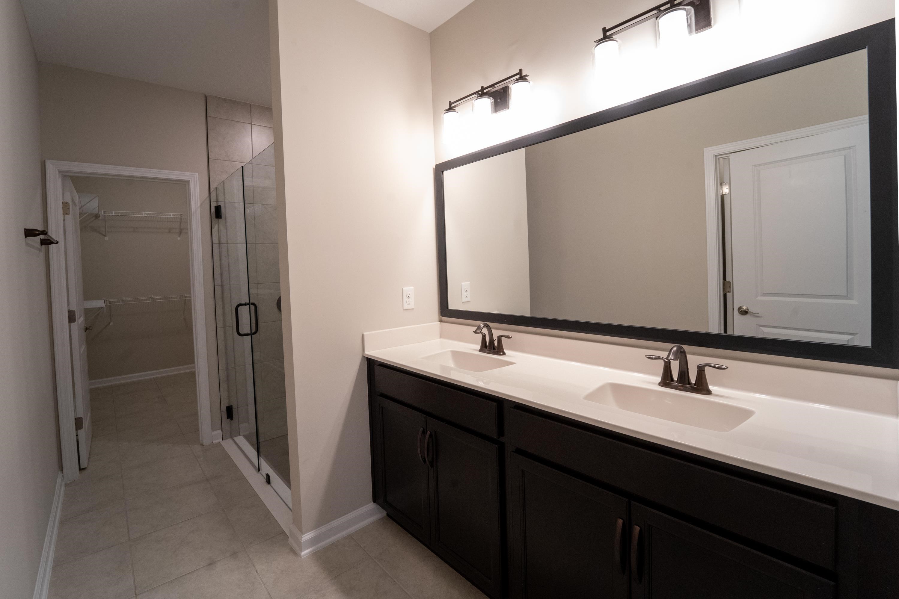 298 Modesto Drive St. Augustine, FL 32086 - Photo 12 of 28 a bathroom with double sink and a mirror