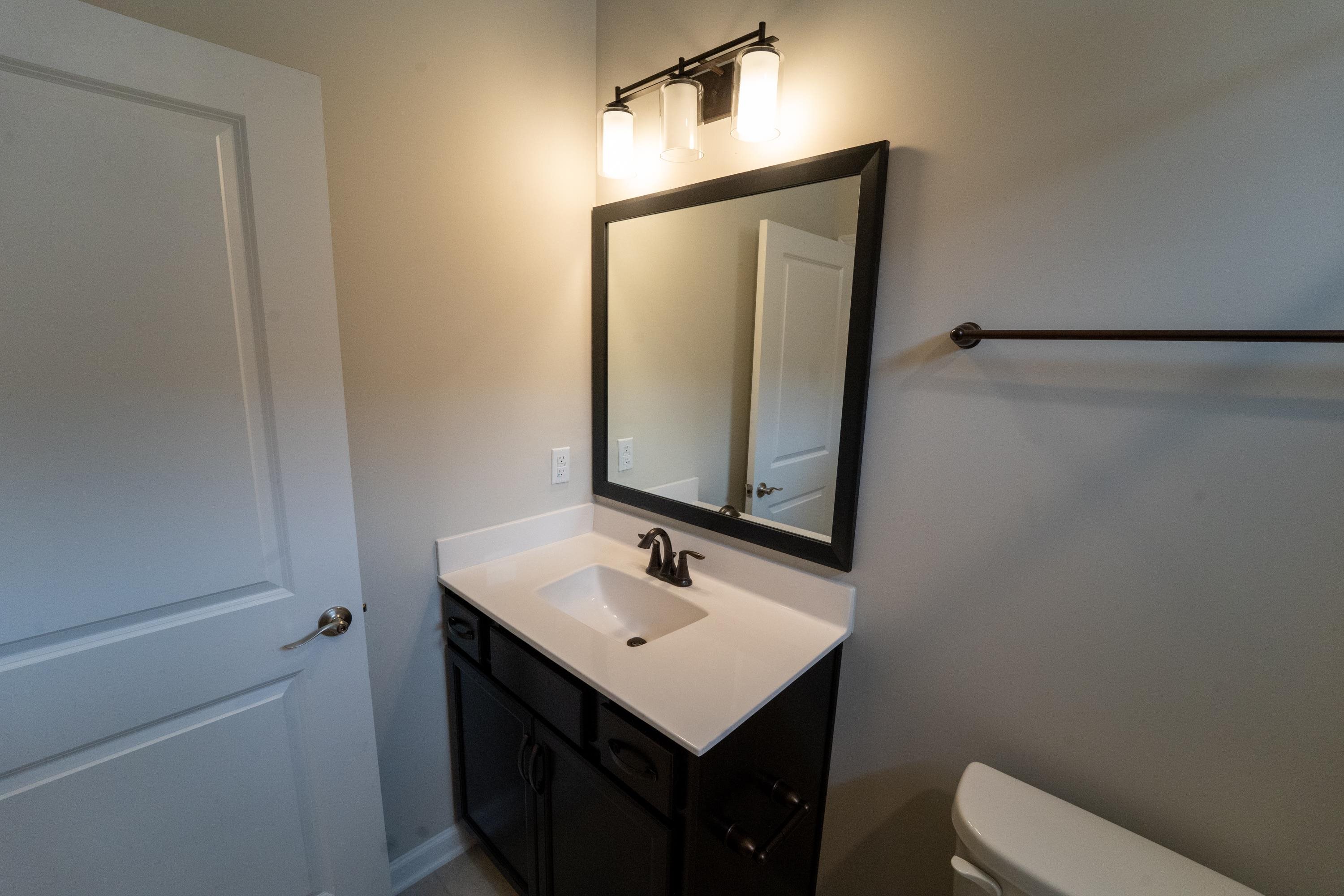 298 Modesto Drive St. Augustine, FL 32086 - Photo 23 of 28 a bathroom with a sink toilet and mirror