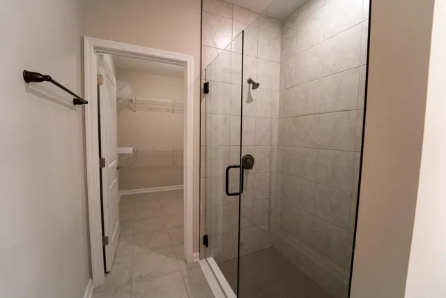 a bathroom with a glass shower door