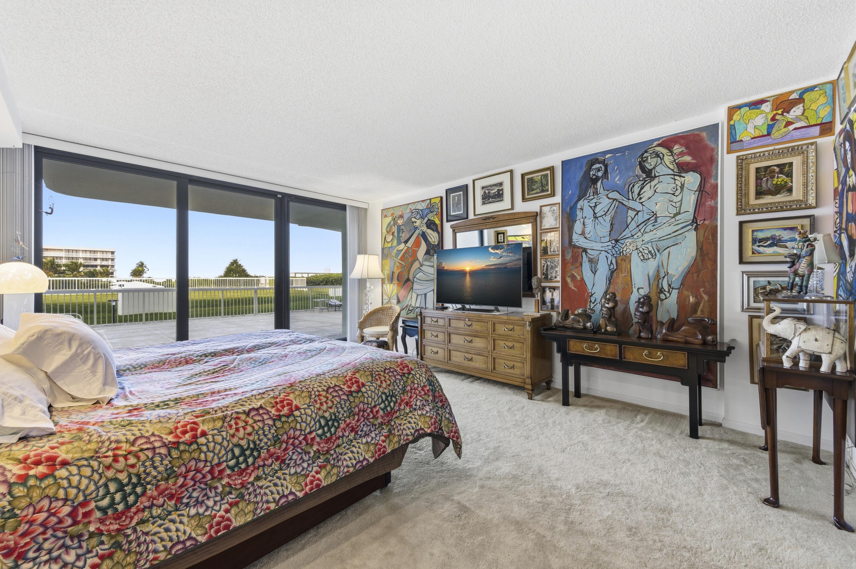 3300 South Ocean Boulevard, Unit 103S Palm Beach, FL 33480 - Photo 11 of 20 a bedroom with a bed and a flat screen tv