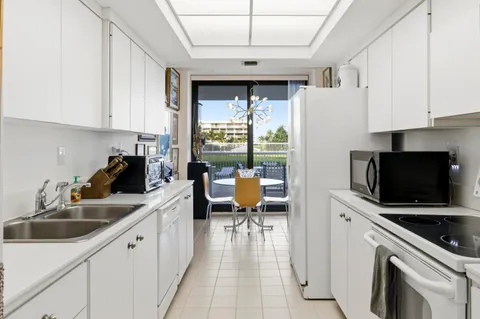 a kitchen with a sink appliances and cabinets