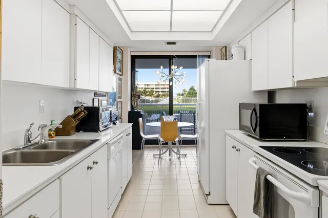a kitchen with a sink appliances and cabinets